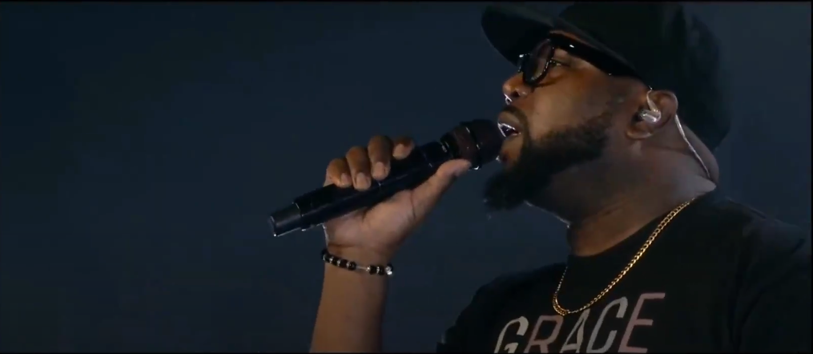 Xavier Jolliff performing on stage with a microphone